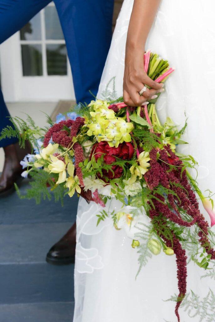 Bride holding colorful bouquet of fresh flowers