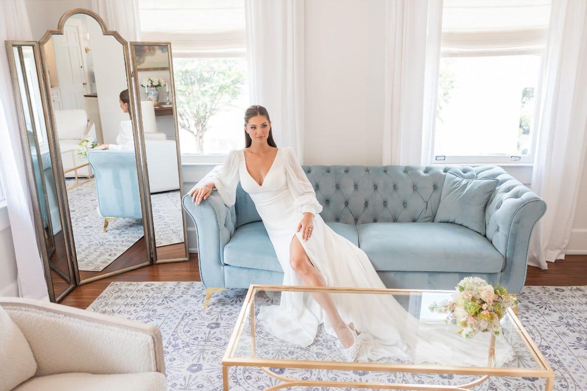Woman in white dress sitting on couch